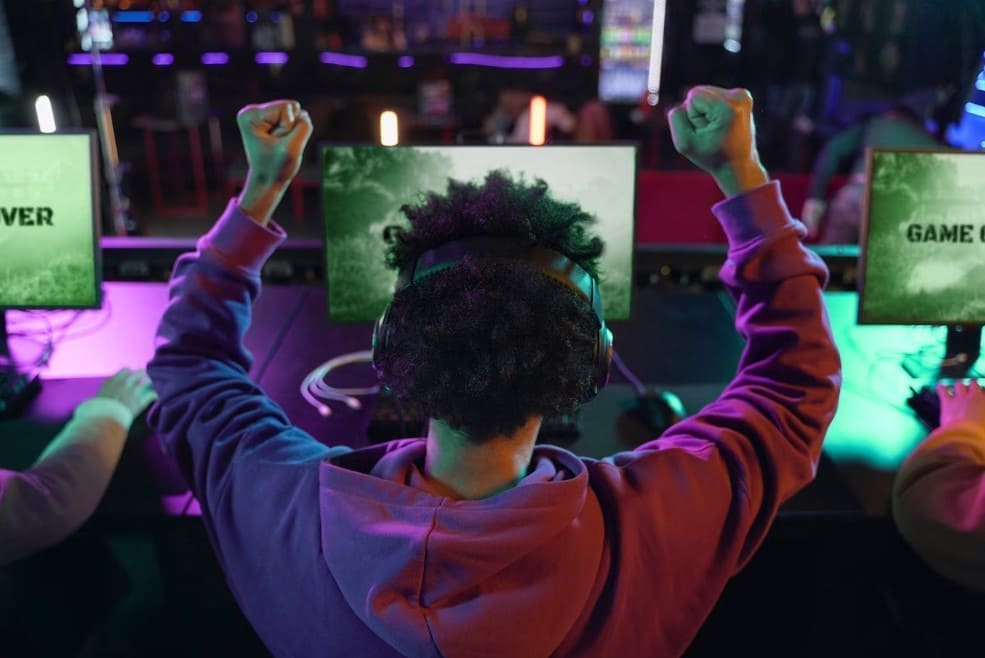 Johnny24 esports betting - professional gamer celebrating victory at gaming tournament